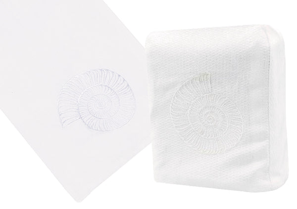 White Italian linen napkins with a hand embroidered Nautilus Shell Collection, White design, one folded diagonally and the other displayed fully. (Haute Home)