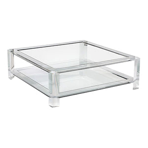 The Surrey Square Acrylic Cocktail Table by Interlude Home features a glass top, lower shelf, straight legs, and a sleek contemporary design.