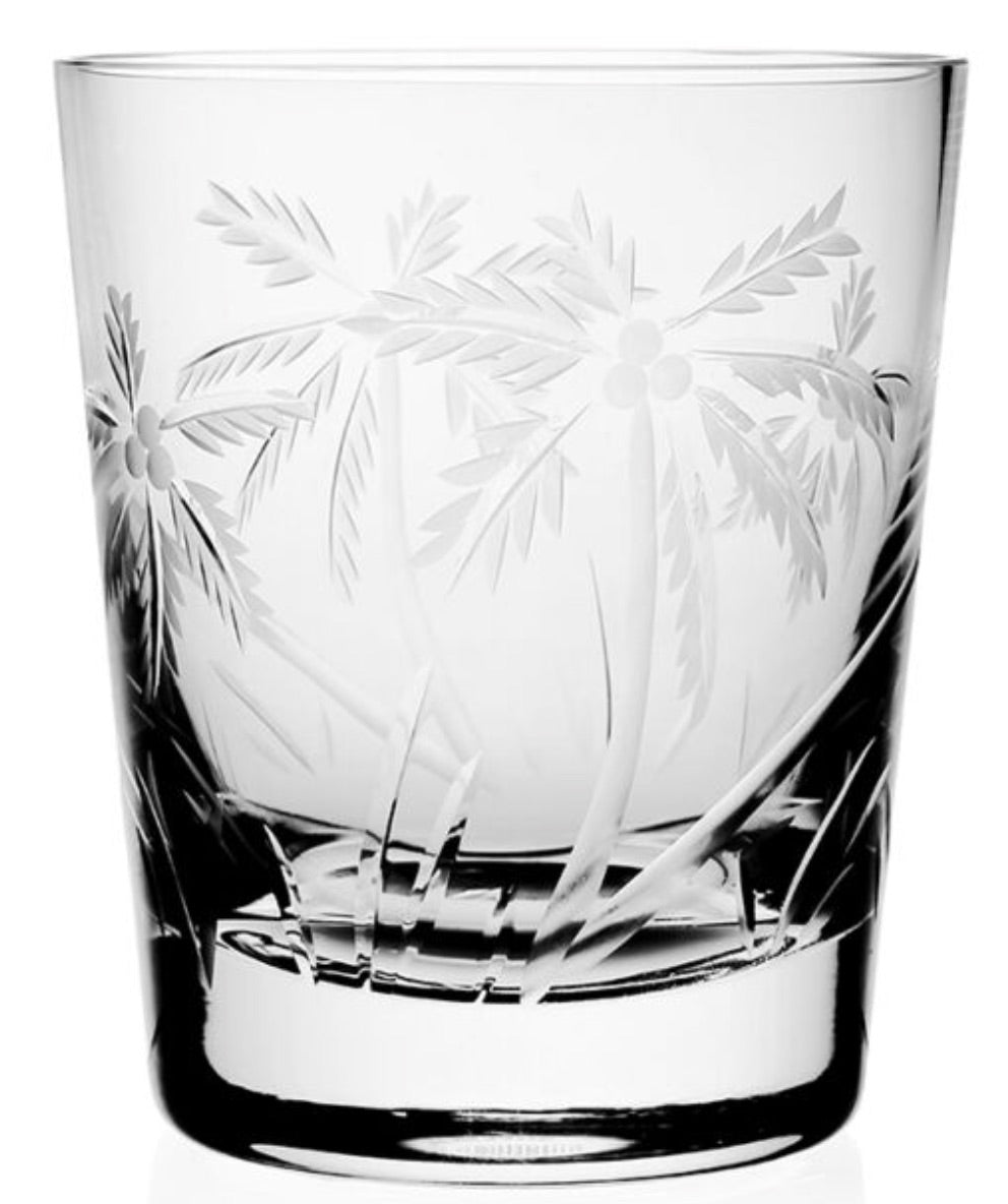 A clear glass tumbler from the William Yeoward Crystal Palmyra Drinkware Collection, etched with palm trees and grass inspired by the Palmyra Atoll’s landscape and marine research.
