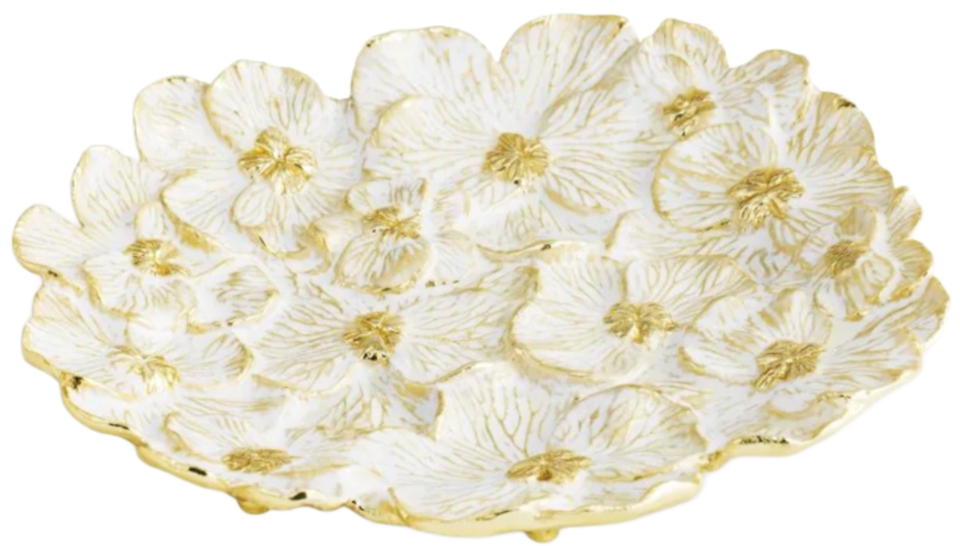 The Michael Aram Orchid Catch All is a decorative ceramic plate from the Orchid Collection, featuring a white and gold floral pattern inspired by black orchid petals, with embossed details and gold-accented edges.