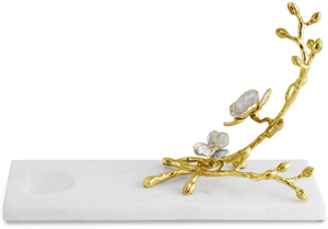 The Michael Aram Orchid Wine Rest is a rectangular white marble tray from the Orchid Collection, featuring a gold and silver floral branch for a look of refined luxury, purity, and grace.