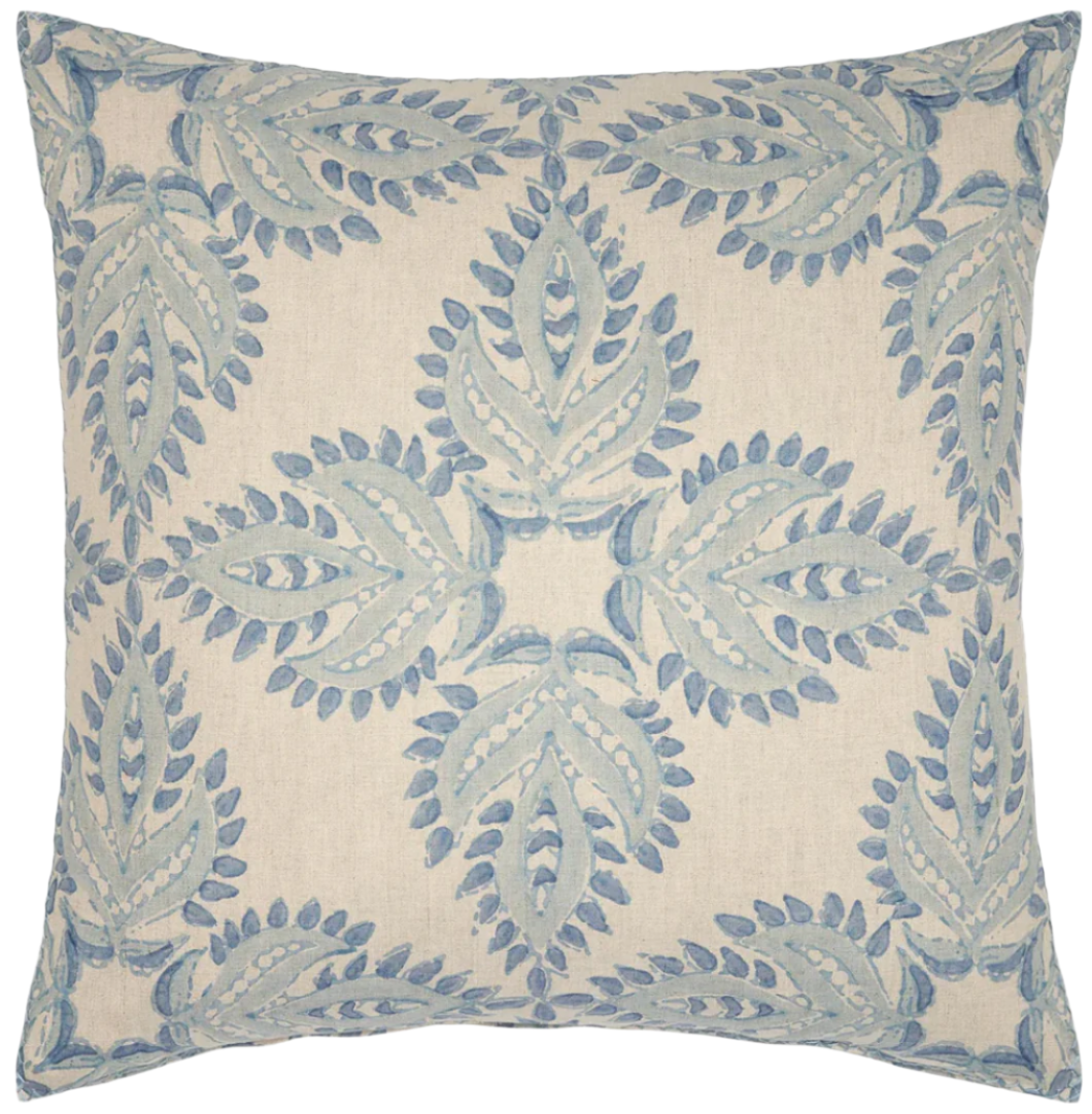 The Verdin Lapis Pillow by John Robshaw is a square decorative cotton linen cushion with a cream base and symmetrical blue embroidered leaf motifs inspired by traditional block prints.