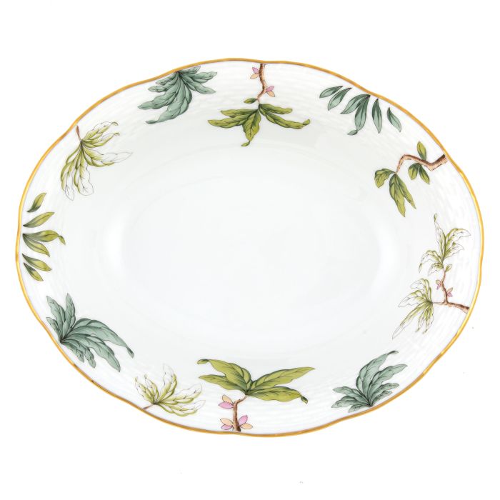 The Herend Foret Garland Collection features an oval white ceramic plate with a gold rim and green leafy branch designs, showcasing artistic porcelain elegance.