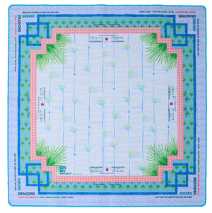 The Mahjong Mat Collection by Oh My Mahjong features a square neoprene, non-slip game board with bamboo designs, blue and pink borders, and marked areas for dragons, jokers, winds, and instructions around the edges.