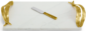 The Michael Aram Palm Cheese Board with Knife is a rectangular white marble tray from the Palm Collection, featuring sculpted textures and antique gold-finished handles, paired with a matching gold-handled knife.