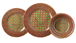 Three plates from the Mario Luca Giusti Patagonia Green Melamine Dinnerware Collection, featuring modern shapes with a green geometric and brown lattice design, are arranged side by side in descending size.