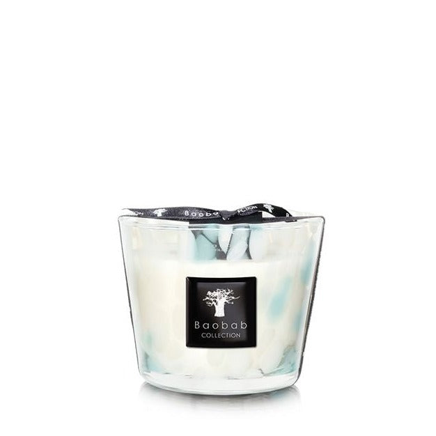 A Baobab Pearls Sapphire candle in a hand-blown glass container with a swirling white and turquoise design.