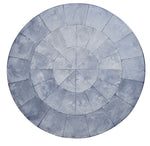 The Kim Seybert Capiz Placemat features concentric circles and radial lines, dividing the surface into sections and creating a striking table backdrop.