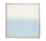 The Kim Seybert Dip Dye Napkin Set features square cloth napkins with a light beige border and a hand-dipped gradient that fades from off-white to light blue—perfect for elevating your table with elegant ombre style.