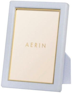 A rectangular Piero Leather Frame from AERIN in light blue with gold detailing and a stand—an elegant way to showcase your cherished memories.