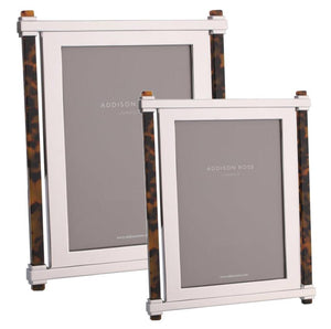 Two Addison Ross Faux Tortoise Pillar & Silver Frames, one large and one small, stand elegantly side by side, each featuring tortoise acrylic accents and soft velvet backstands from the coveted collection.