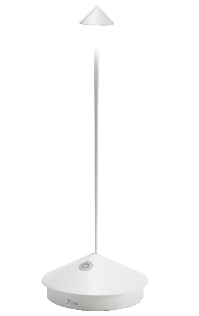 The Zafferano America Pina Lamp Collection features modern, minimalist white desk lamps with a conical shade and slender stem, offering touch dimming and portability for versatile indoor or outdoor use.