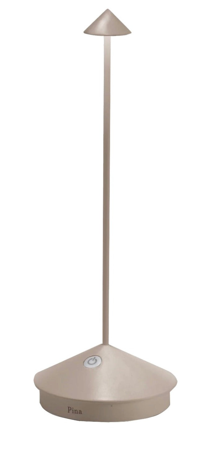 The Pina Lamp Collection by Zafferano America features a modern, minimalist desk lamp with a conical base and shade, slim vertical stem, and touch-dimmable button—ideal for any space.