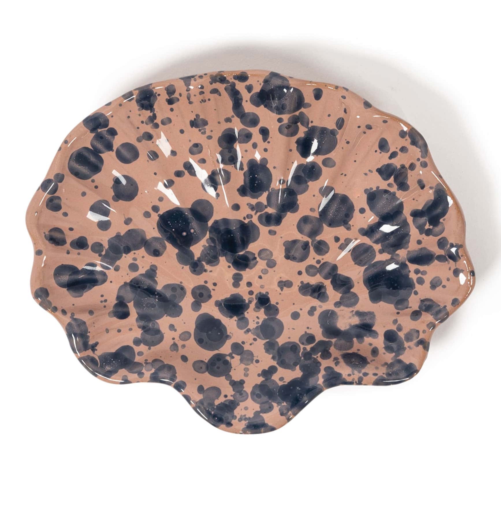 The Splatter Coquillage Dish Collection by Sharland England features scallop-shaped shell dishes with a brown base and irregular black splatters, handmade in Italy—perfect as a chic gift for any occasion.