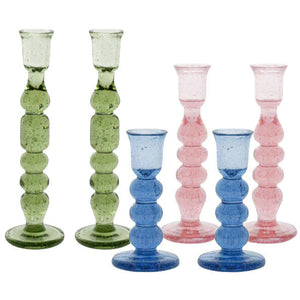 The Juliska Provence Candlestick Set features six mouth-blown glass holders in green, blue, and pink, arranged in two rows on a white backdrop to highlight their vibrant colors.