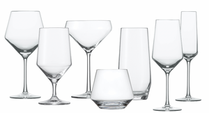 Seven empty, clear wine and champagne glasses from Fortessa's Pure Collection, featuring postmodern tabletop aesthetics, are arranged against a white background.