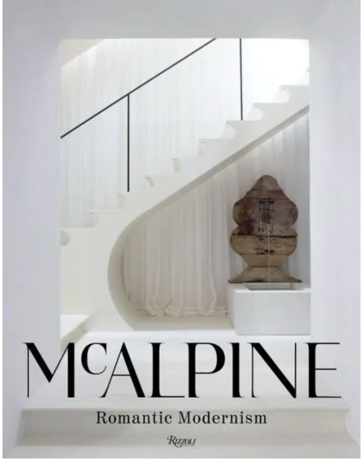 Cover of the book "McAlpine: Romantic Modernism" by Rizzoli, featuring a modern white interior with a curved staircase and an art piece on a pedestal. The architectural design merges seamlessly with McALPINE's signature romantic modern aesthetic.