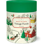 The Peace On Earth 500 Piece Puzzle by Cavallini Papers and Co features vintage winter village imagery in a cylindrical container—a charming holiday puzzle perfect for the season.