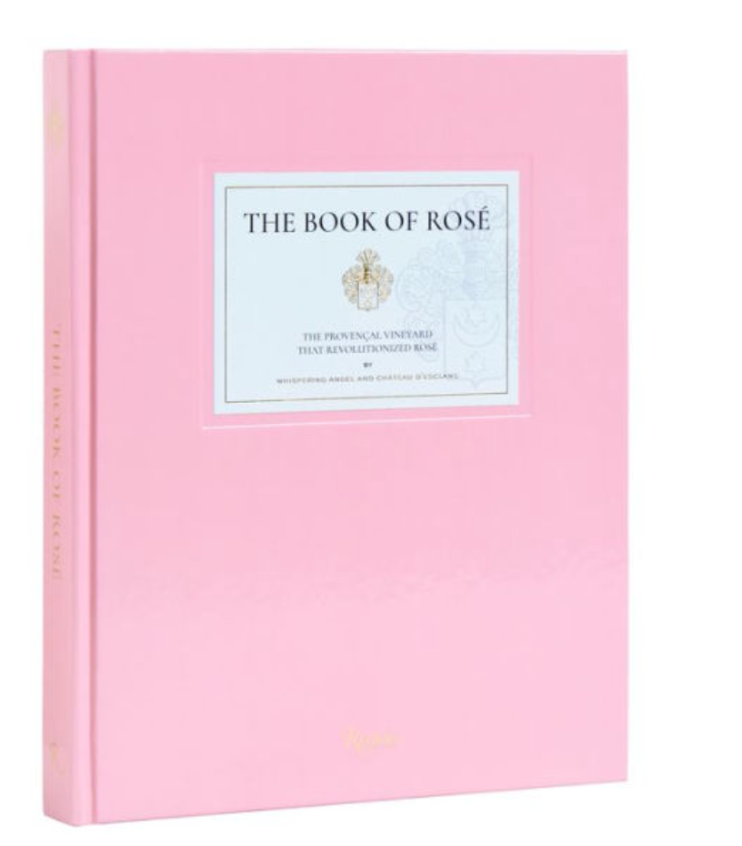 The Book of Rosé by Whispering Angel and Château D'Esclans, from Rizzoli, is a light pink hardcover celebrating Provence style and iconic rosé wines.