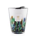 A Baobab Rainforest Amazonia candle in a glass featuring a colorful, abstract design and infused with Amazonia scented bergamot for vegetal freshness.