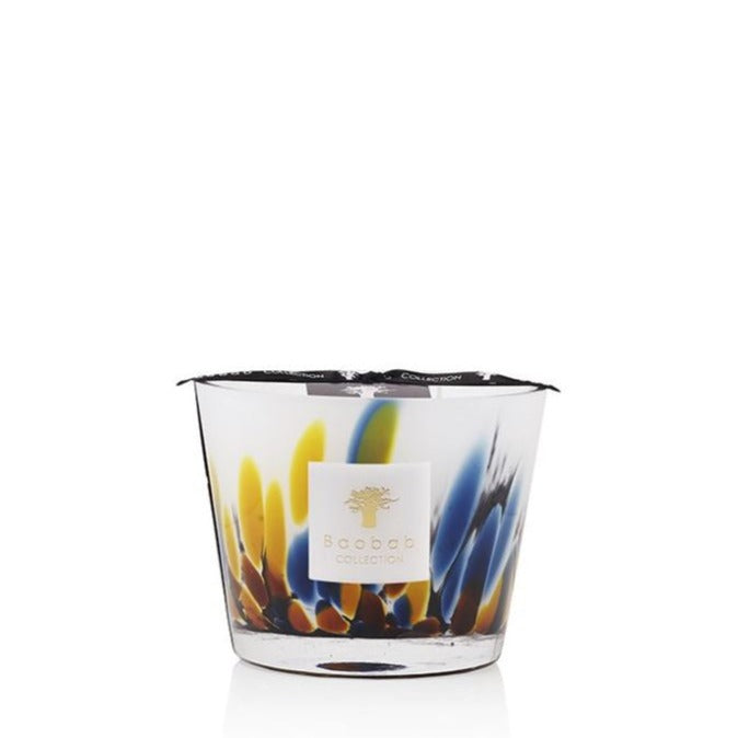 A colorful Baobab Collection Rainforest Mayumbe candle in a clear glass jar with vibrant blue and yellow feather designs.
