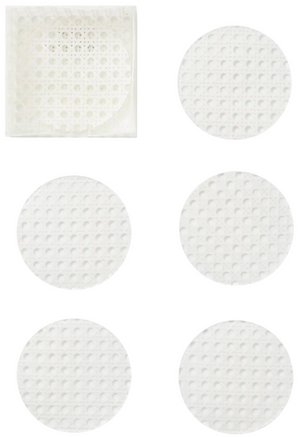 The Kim Seybert Reed White Coasters Set features six white, textured circular coasters resembling faux-wicker, with one displayed inside a clear square container in the top left corner.