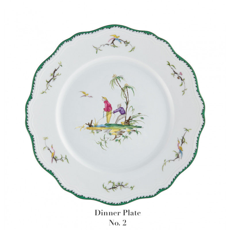 Raynaud Longjiang Dinnerware Collection dinner plate features white porcelain, a scalloped green-trimmed edge, floral accents, and a central pastoral scene with two figures by a tree, inspired by Vieux Marseille faience. Text: "Dinner Plate No. 2.