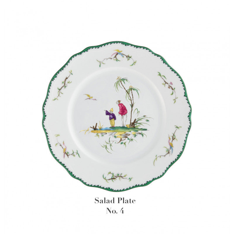 The Raynaud Longjiang Dinnerware Collection features a white salad plate with a scalloped green rim, two figures by a tree in a pastoral scene, floral motifs, and "Salad Plate No. 4" text— inspired by Vieux Marseille faience.