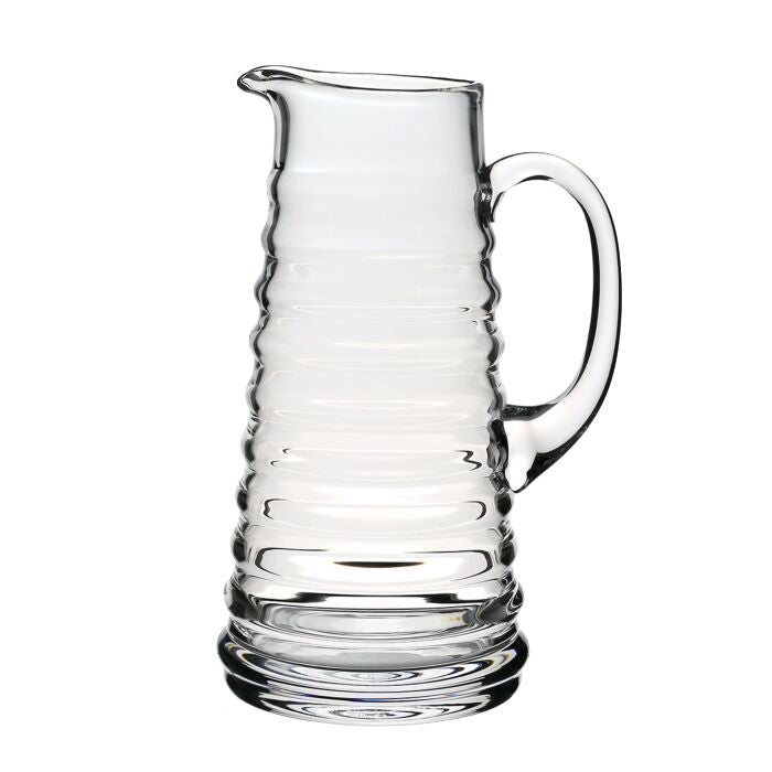 William Yeoward Crystal Ripples Serveware Collection: Clear glass pitcher with ribbed design and curved handle, photographed on a white background for an artisanal touch.