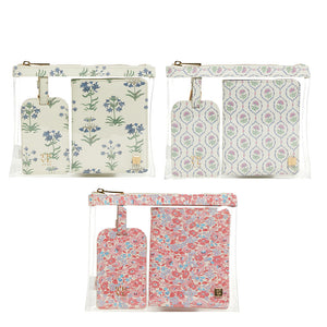 Three clear zippered pouches, each with a matching passport cover and luggage tag in green, lavender, and pink floral prints—it's the TRVL Design LUXE Saffiano Travel Set, beautifully displayed on a white background.