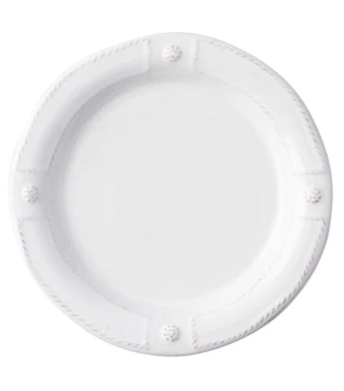 A plain white ceramic plate from Juliska's Berry & Thread French Panel Dinnerware Collection, featuring a slightly raised rim with four decorative knobs, inspired by classic Parisian architecture.