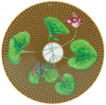 The Tresor Fleuri Marron Dinnerware Collection by Raynaud features hand-painted plates with a brown textured surface, green leaves, and a central pink flower, adding narrative richness to any setting.