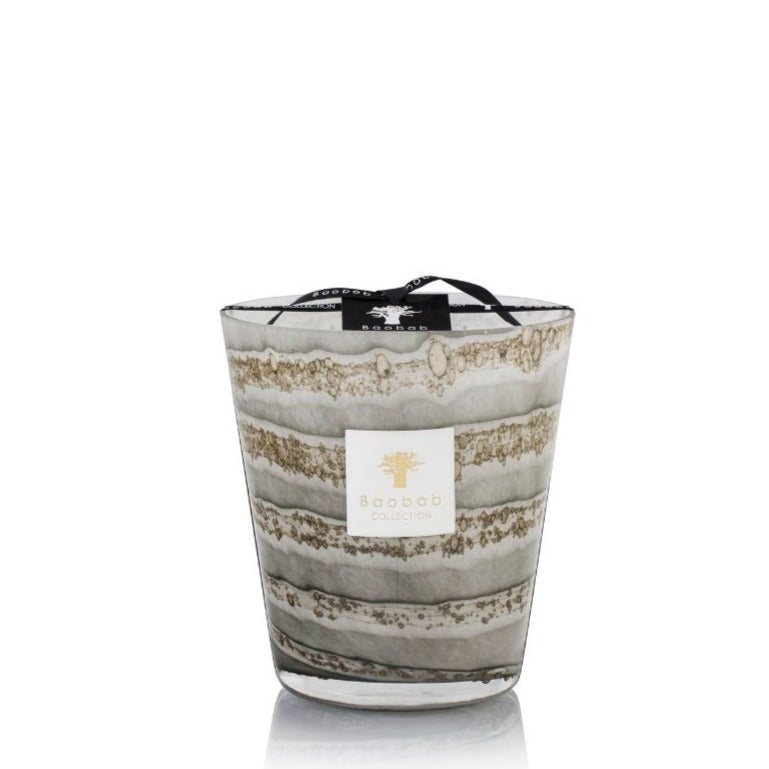 A Baobab Sand Atacama candle in a large glass holder with layered beige and gray designs, isolated on a white background, infused with Earl Grey Tea scent.