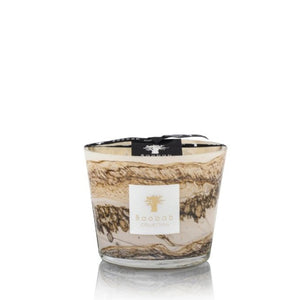A Baobab Sand Siloli candle in a clear glass jar with beige and brown swirl design, isolated on a white background, featuring green lemon scent.