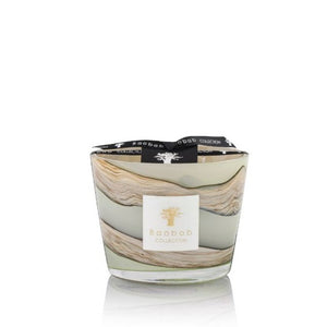 A Baobab Collection Sand Sonora Candle with patchouli in a marbled glass container with the brand's logo on a label, isolated on a white background.