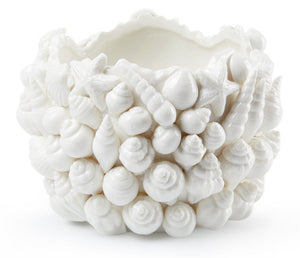 The Villa & House Sanibel Vase features raised seashell and starfish motifs on Blanc de Chine porcelain, giving it a textured, coastal look.