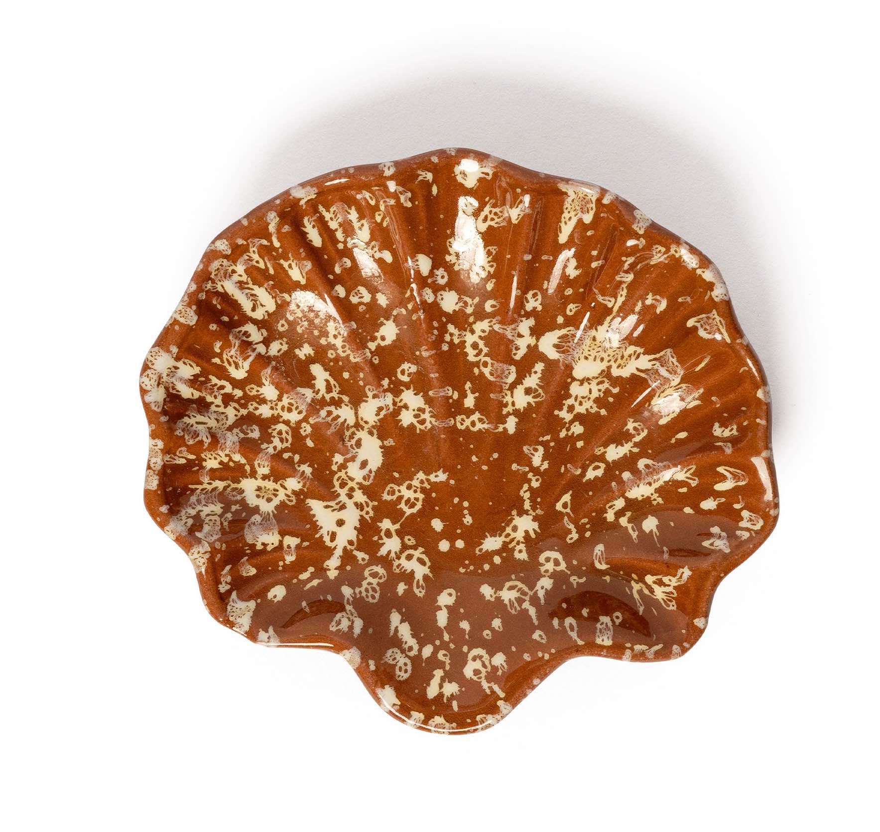 The Chic Gift Hamper by Sharland England features a brown ceramic bowl with a ruffled, shell-like shape and cream-speckled pattern—ideal for artisanal gifts or hand-poured candles—shown on a white background.