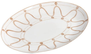 Themis Z's Serenity Beige Serving Platter is an oval white ceramic plate with organic hues and a tan wavy line and dot pattern decorating the rim.