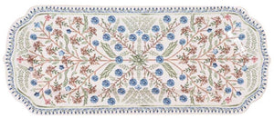 The Juliska Villa Seville Chambray Hostess Tray is a rectangular ceramic platter featuring a symmetrical floral motif in blue, green, and brown, inspired by the Spanish countryside and finished with a decorative trim.
