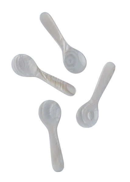 Four Be Home Seashell Spoons arranged randomly on a white background.