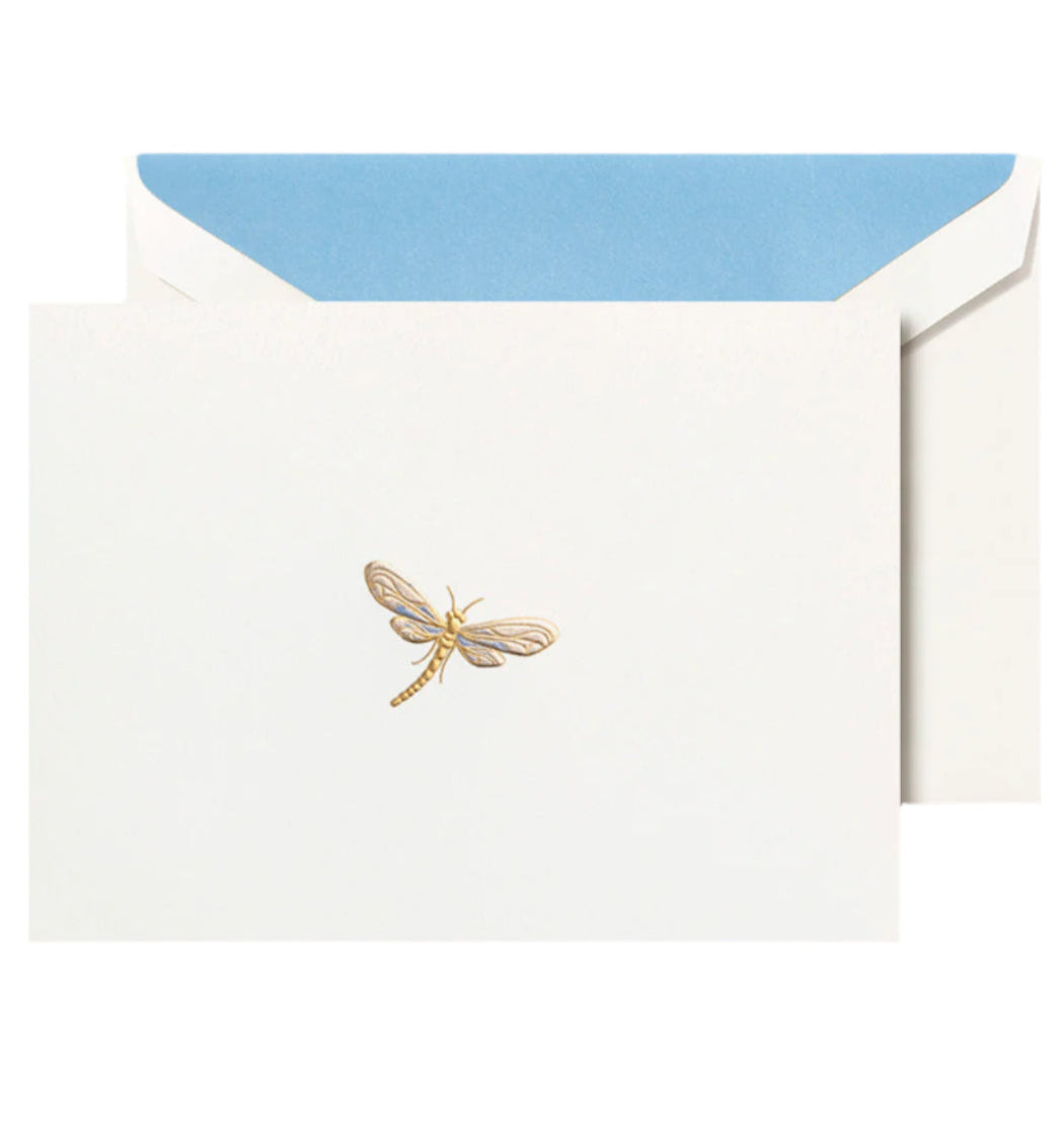 The Crane Dragonfly Card Set features a white card with a gold dragonfly illustration, partially tucked into an envelope lined with blue.