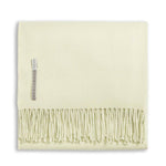 The Alicia Adams Alpaca Classic Throw Collection features a folded pale yellow baby alpaca blanket with fringe and a fabric label, fair-trade made in Peru—a soft, luxurious accent for any space.