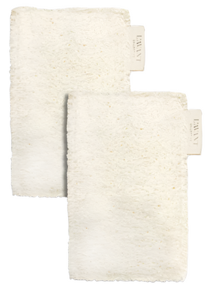 Pair these two off-white, textured washcloths—each with a "Lavant" tag—with L'Avant Collective Eco Friendly Sponges (Set of 2) for a plastic-free, sustainable cleaning routine.