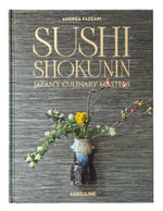 The Assouline book "Sushi Shokunin: Japan's Culinary Masters" is ideal for sushi enthusiasts and celebrates culinary artistry, with a cover depicting a floral vase on a textured gray background.