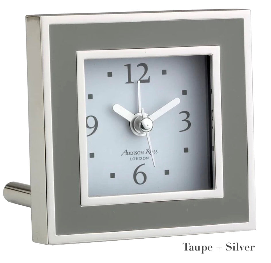 The Addison Ross Silver Square Alarm Clock from the Addison Ross collection features a taupe border with black numerals and silver hands on a gray face, showing 10:08. Elegant as a bedside clock, it displays "Taupe + Silver" text at the bottom right.