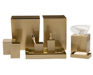 The Temara Honeycomb Bath Collection by Pigeon & Poodle features gold-finished bins, trays, soap dispenser, tissue box, toothbrush holder, and soap dish with a subtle honeycomb pattern—all showcased on a white background.