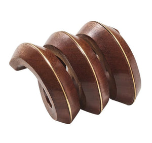 The Kim Seybert Tendril Napkin Ring features hand-carved wood with smooth spiral curves and light-colored edges, creating a striking contrast against a white background.