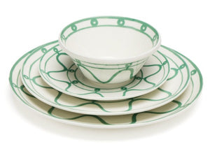 The Themis Z Serenity Green Dinnerware Collection features a set of four white ceramic dishes—bowl, salad plate, dinner plate, and charger—with green patterns in calming organic hues, stacked together.