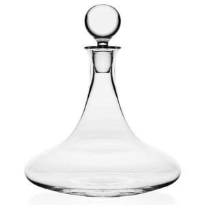 The William Yeoward Crystal Trafalgar Ships Decanter features a wide base and round stopper, ideal for serving wine or spirits, shown against a white background.