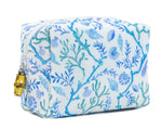 The Coral Vine Bag by TRVL Design is a rectangular, stain-resistant zippered pouch with a blue and white sea-inspired shell and coral pattern, ideal for cosmetics. Finished with a gold zipper pull.